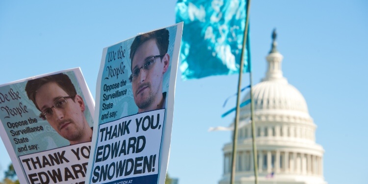 banner with snowden photo in the background of white house