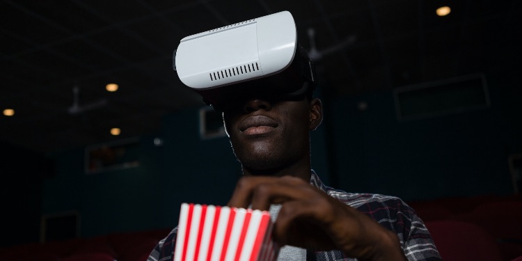 a guy with VR headset and popcorns