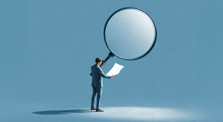 man in blue suit gold huge magnifying glass, read white paper