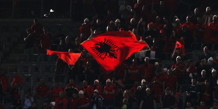 The Albanian flag being revealed at a football game.