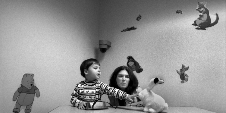 A black and white photo of an autistic child in therapy.