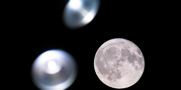 The moon with ominous looking spaceships blurred nearby.