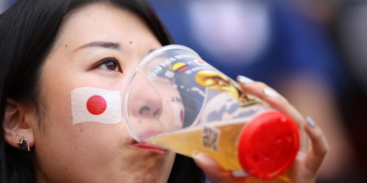 A Japanese fan enjoying beer at the world cup.