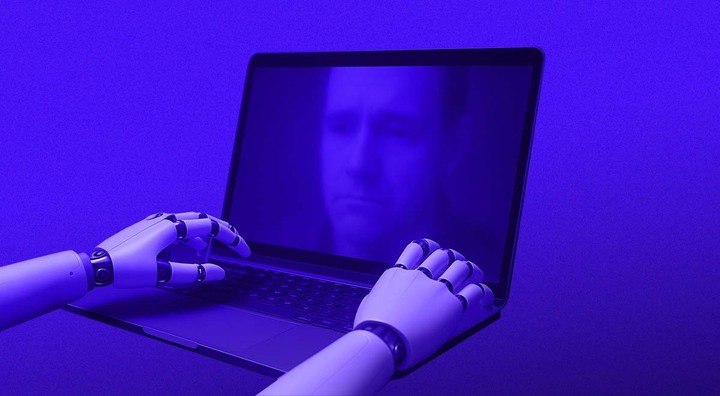 white robot hands on open laptop, sad man on screen, blue shades dominating