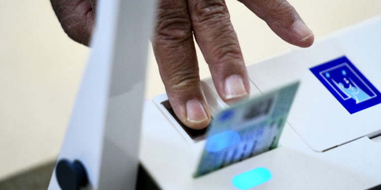 Someone voting in the Iraqi election via fingerprints.