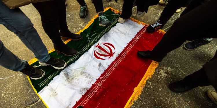 People standing on the Iranian flag out of solidarity.
