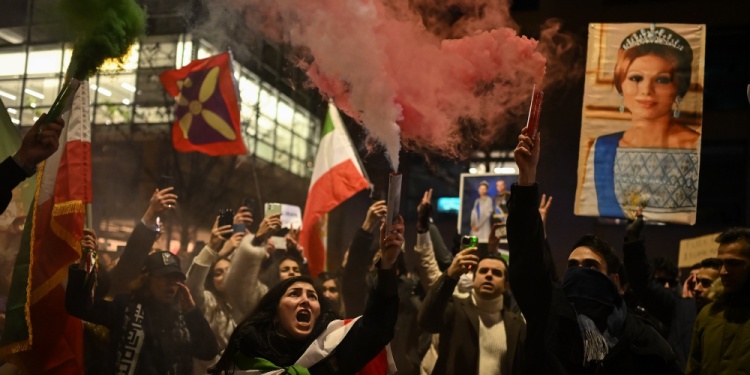 Protestors with smoke and Iranian flags.