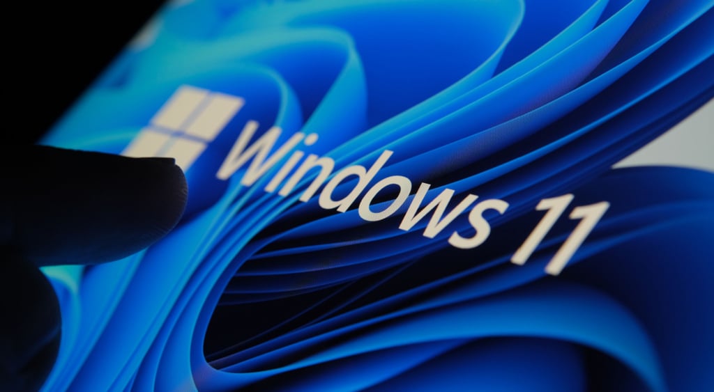 Shadowy hand touching a Windows 11 screen
