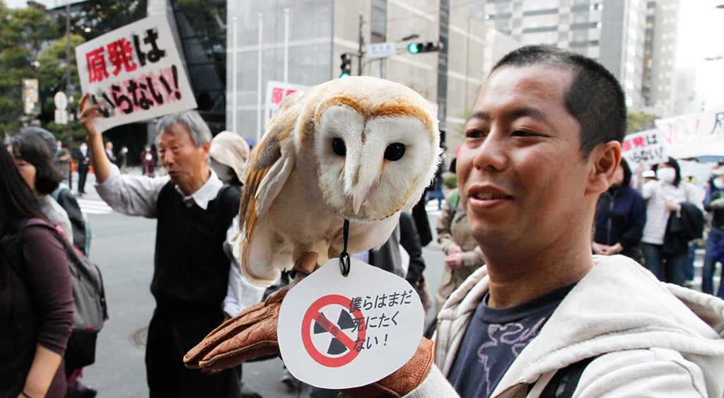 Anti-nuclear protesters march in front of the Tokyo Electric Power Company