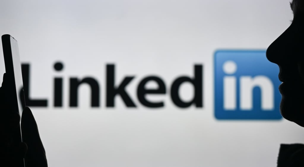 A person talking into their phone with the LinkedIn logo in the background.