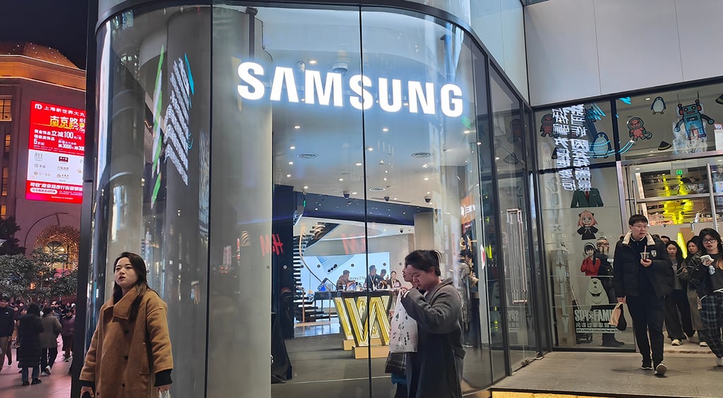 Pedestrians pass Samsung Electronics on Nanjing Road in Shanghai, China