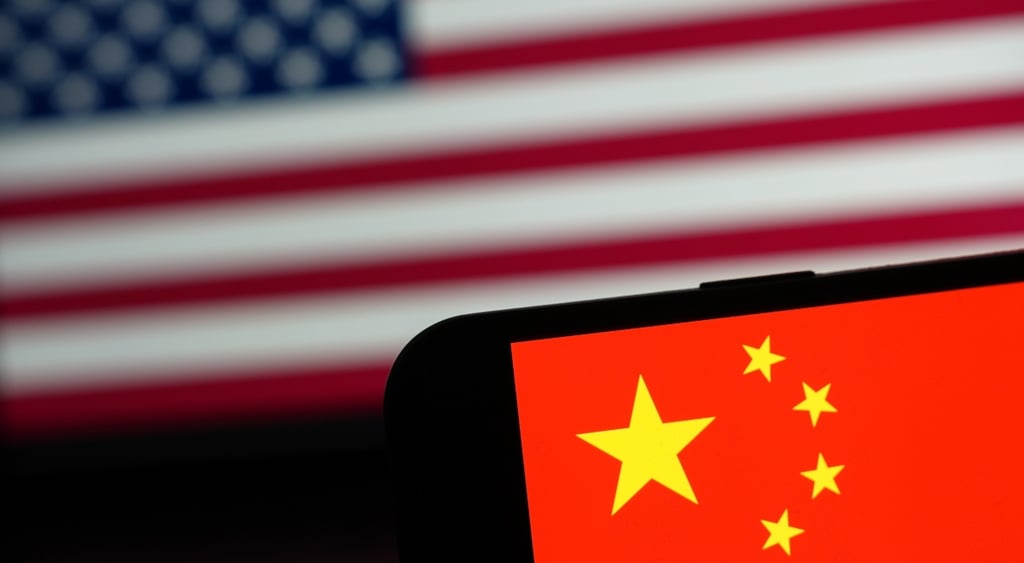 Chinese flag on phone in forefront, US flag in background