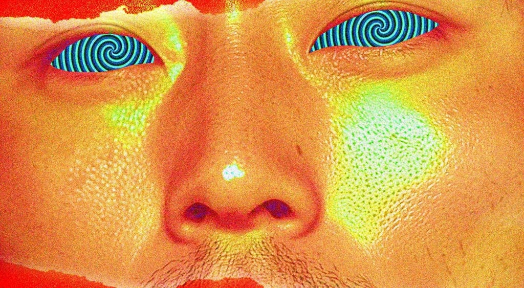 man with gold face and blue-white-black swirly eyes