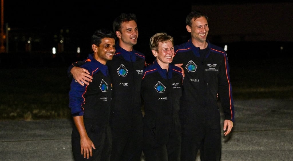 Axiom4 crew in dark blue space suits smiling