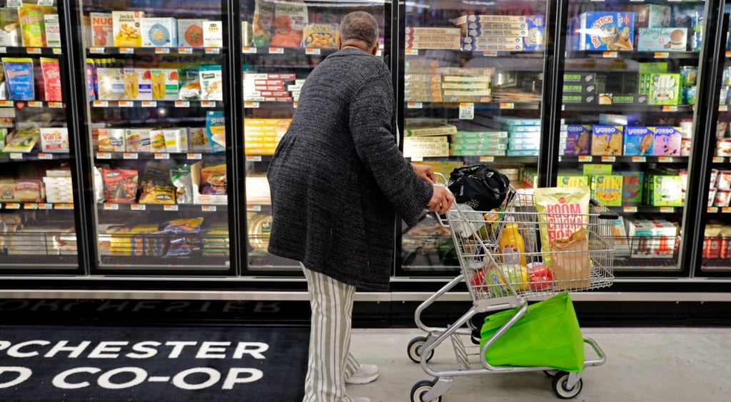 Co-op store inside, black man, fridge, frozen food, pizza, cart