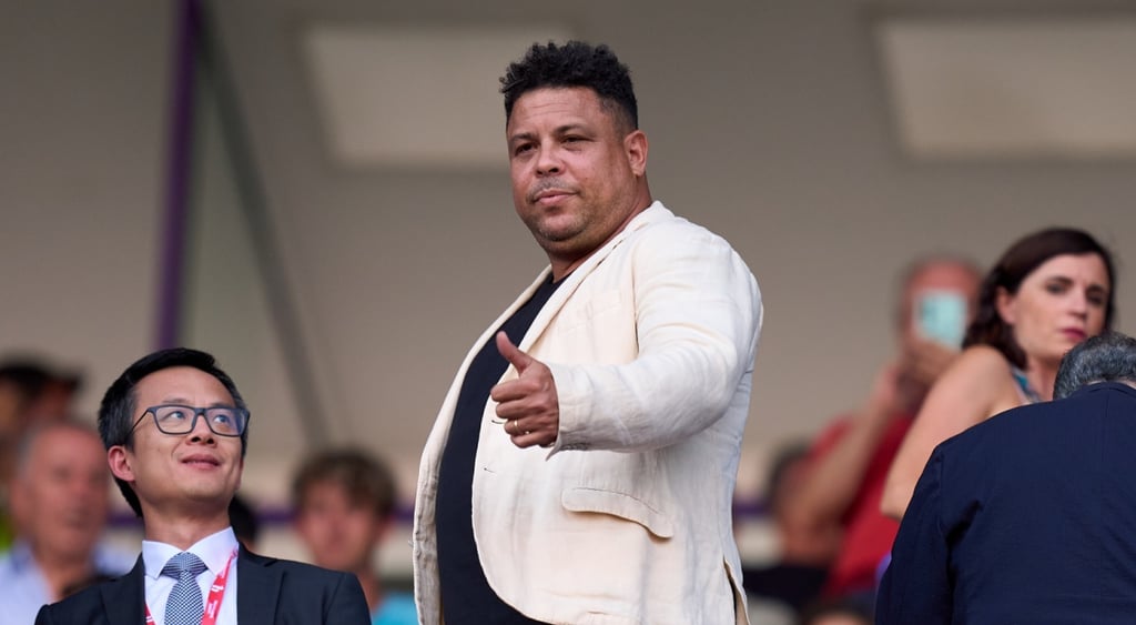 Ronaldo nazário in football stadiu wearing white suit