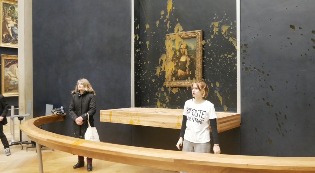 mona lisa, light brown paint, protest, two women, louvre paris