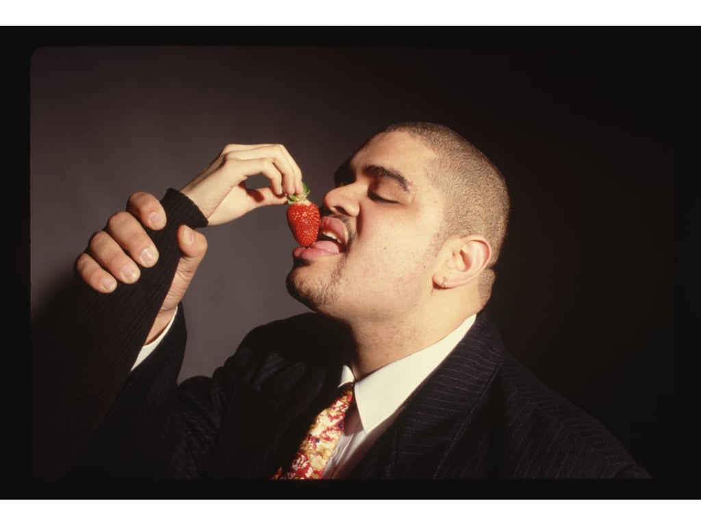 A rapper being fed a strawberry.