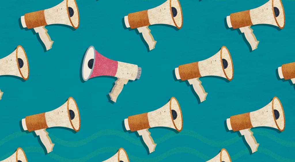 white and brown speakers, green background, one pink speaker