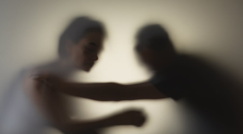 two people behind a filter looking like shadow, right man holds the others shoulder