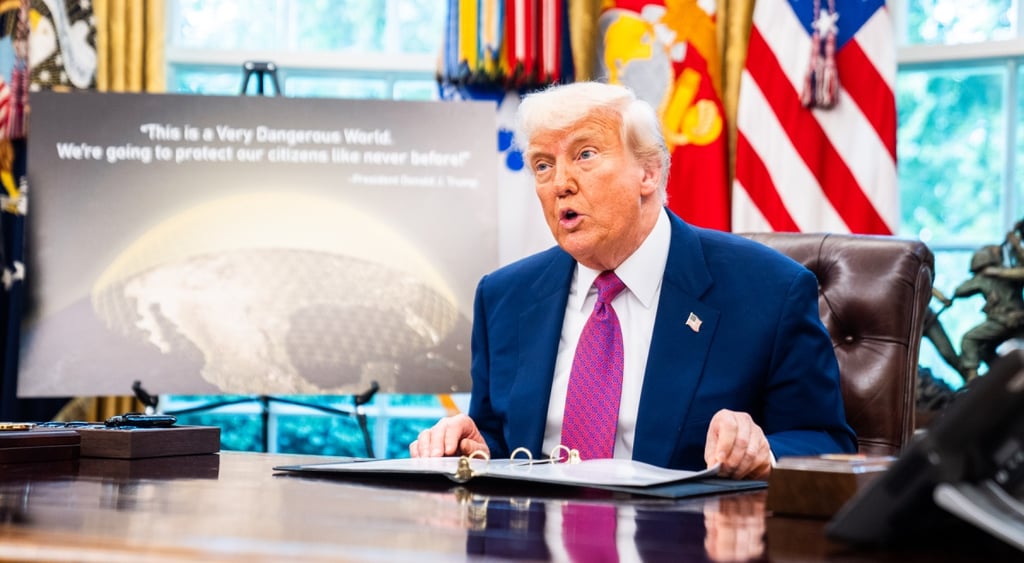 donald trump in oval officew with golden dome presentation
