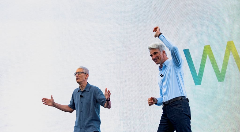 Apple CEO Tim Cook and Craig Federighi peak during Apple's annual World Wide Developers Conference at the company's headquarters in Cupertino, California, U.S., June 9, 2025. Image by Lauren Andrillon | Reuters.