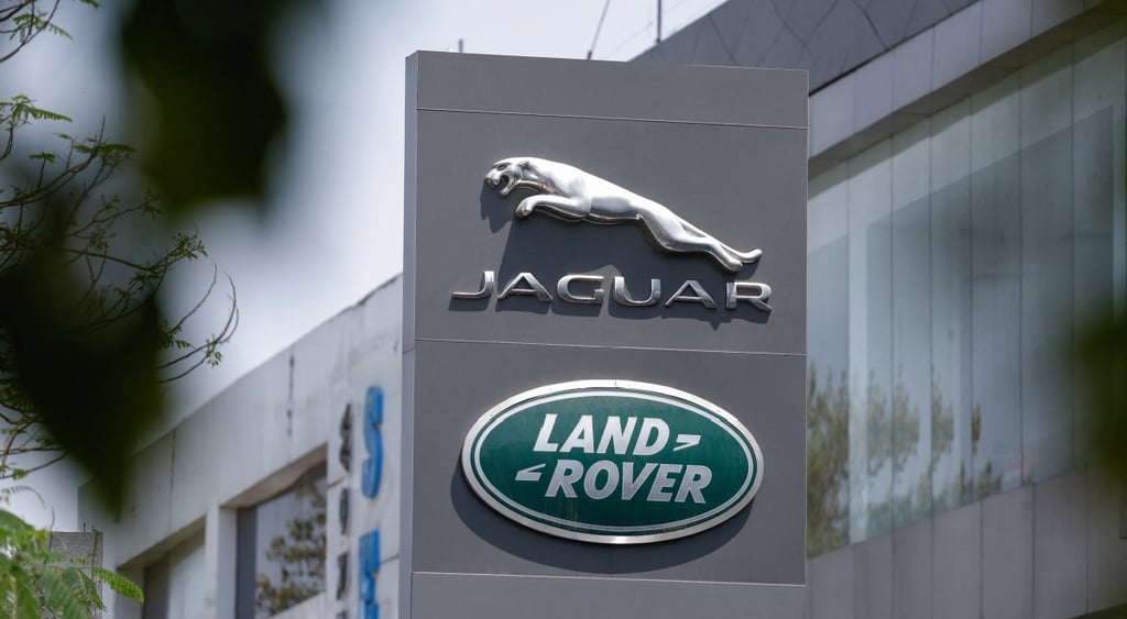 jaguar silver logo and sign, Land Rover logo in green circle