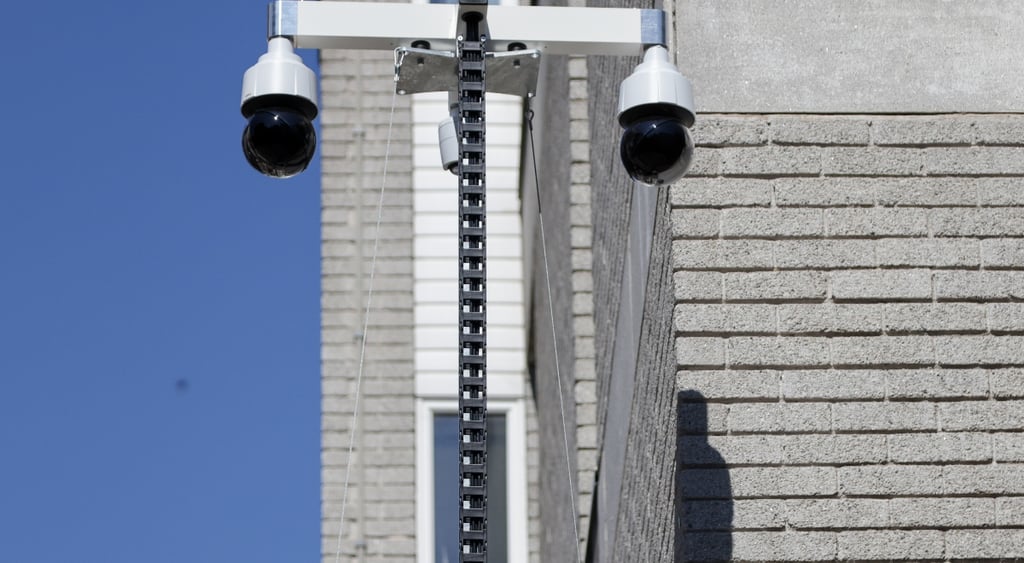 Two facial recognition cameras observing the street