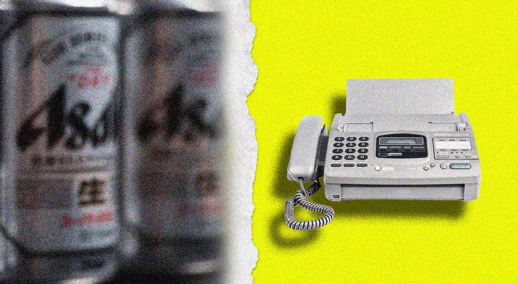 A blurred can of Asahi and a fax machine.