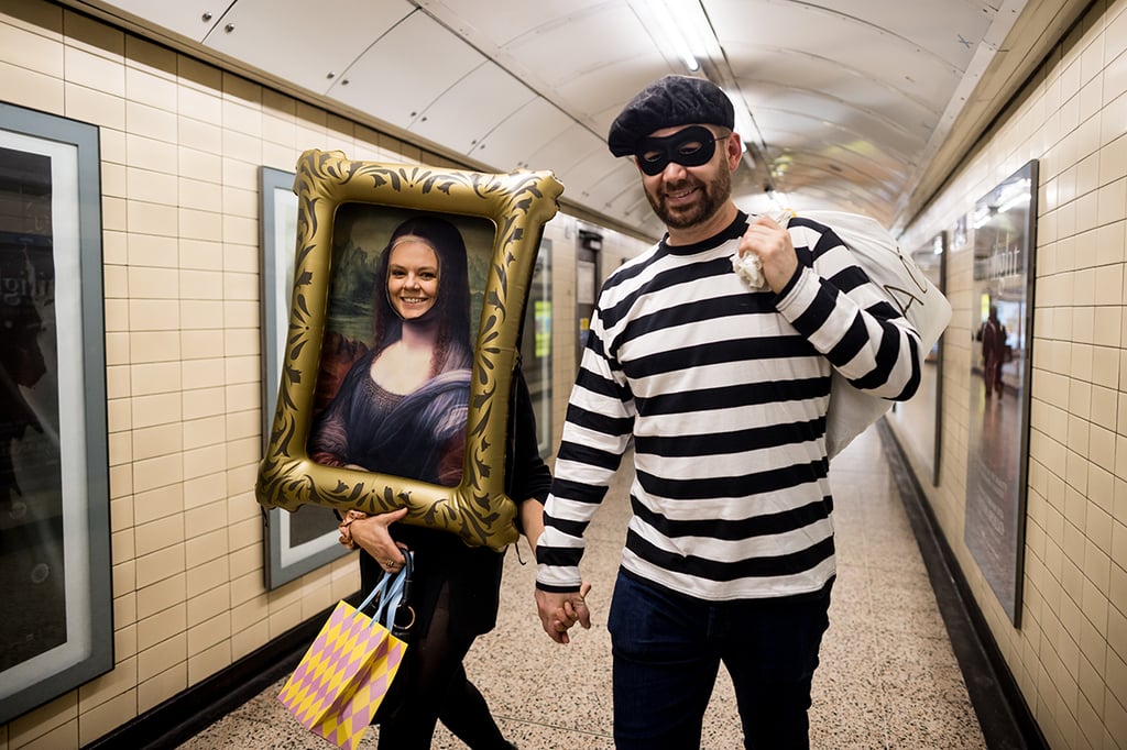 A couple in the Louvre heist Halloween costumes