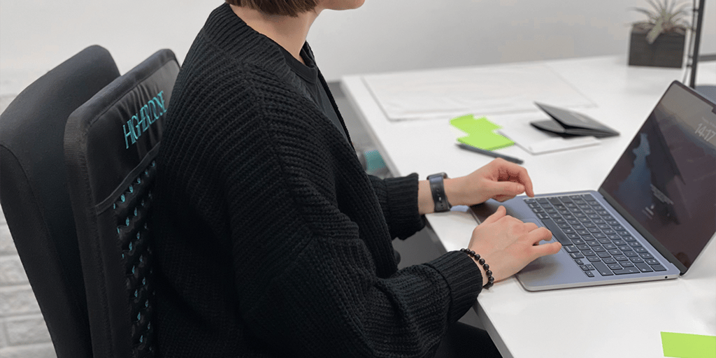 HigherDOSE PEMF Mat in use for lower-back pain relief for people with a sedentary lifestyle
