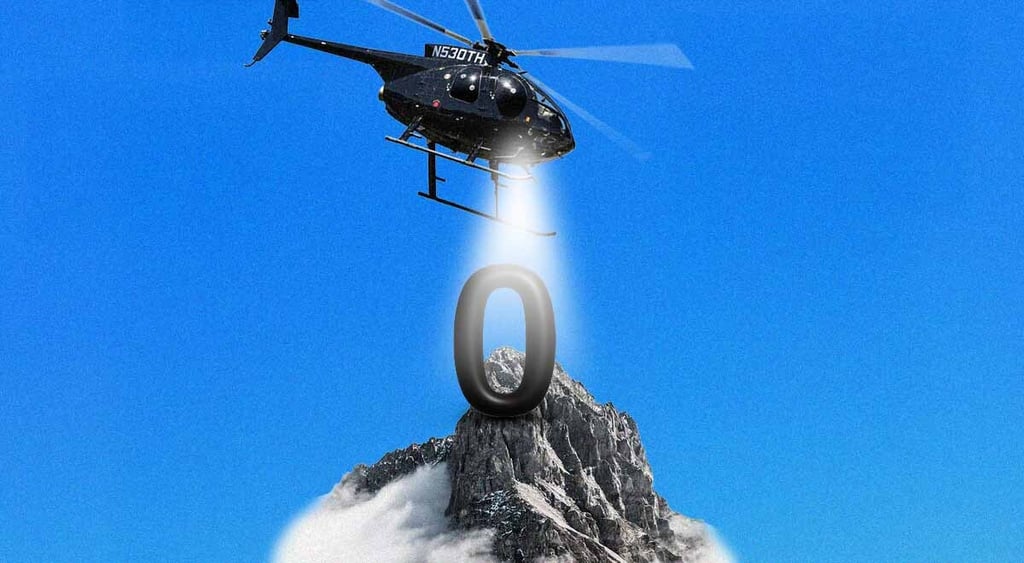 black helicopter shines white light on black zero that's on top of a snowy black mountain