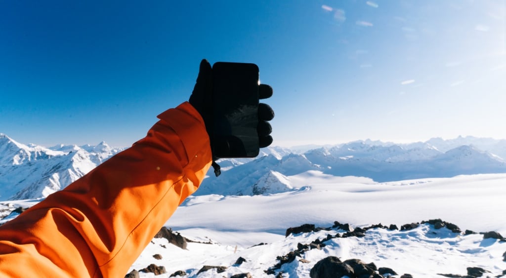 Hand holding a phone in winter