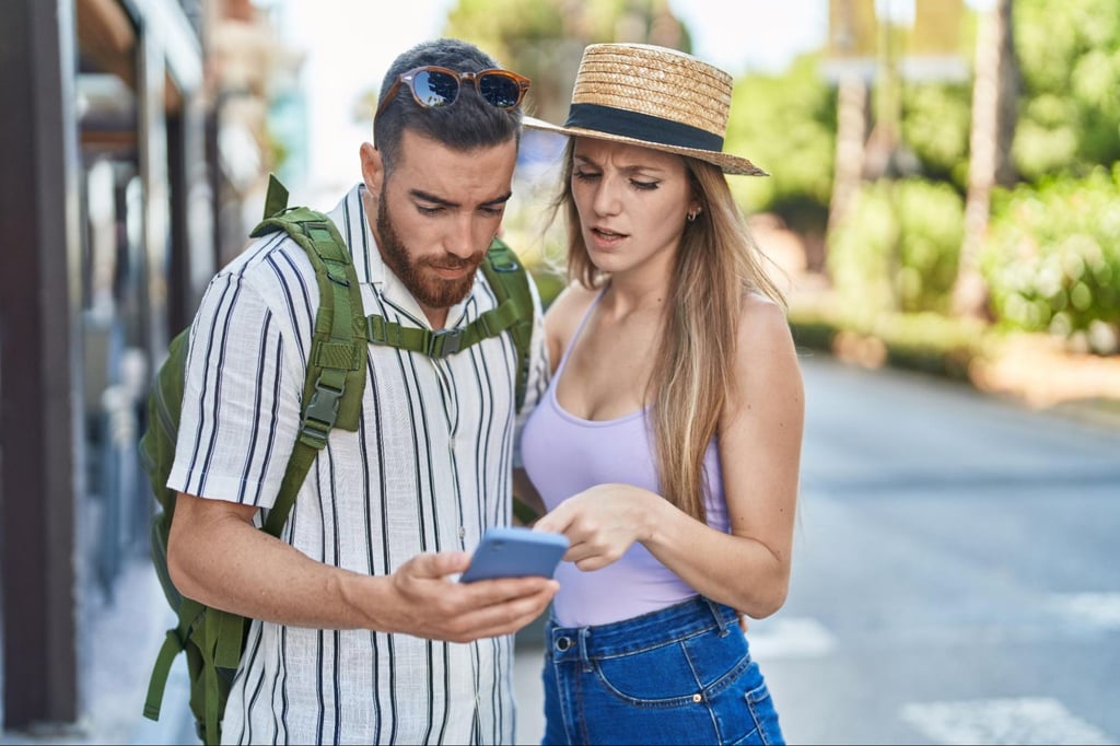 couple looking at phone outside