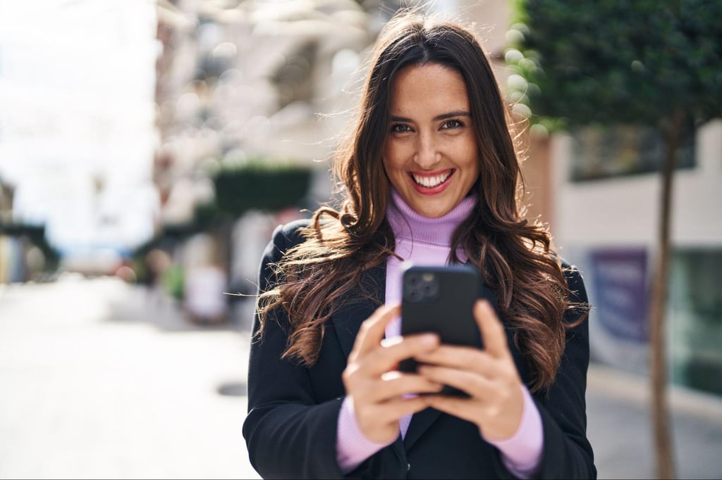 woman looking at phone outside