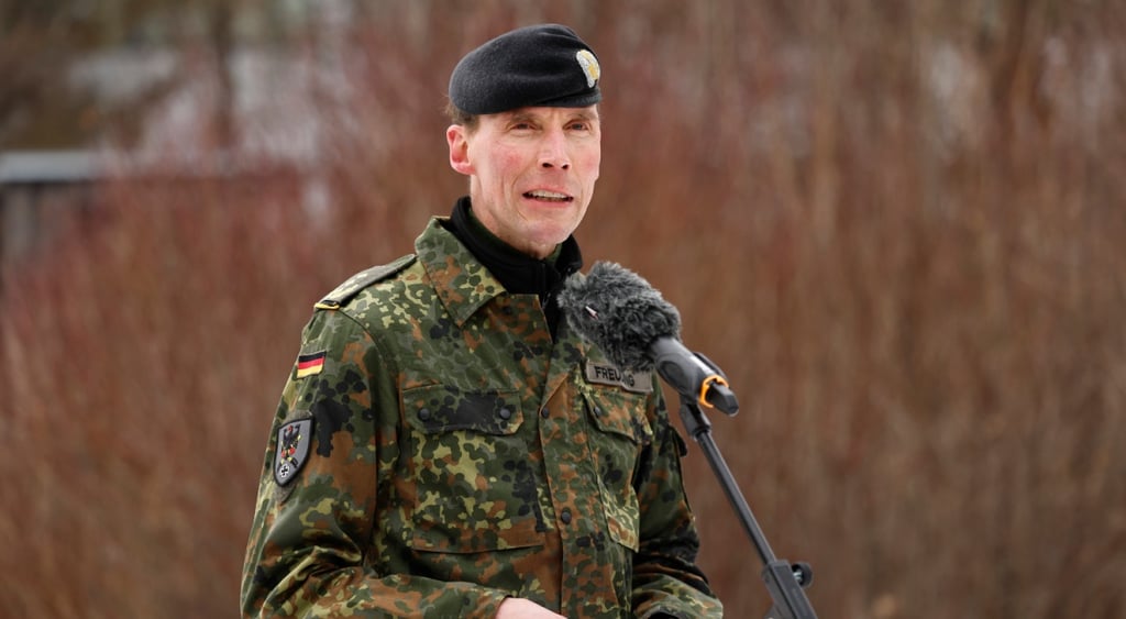 Lieutenant General Christian Freuding, white man in army uniform, had, microphone, reeds.