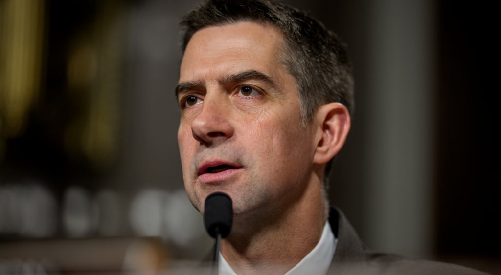 senator Tom Cotton, close up, little black microphone, white shirt collar, dark eyebrows, short hair