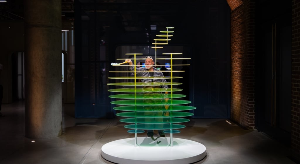 old man, grey beard dusting Apple logo made of horizontal glass pieces