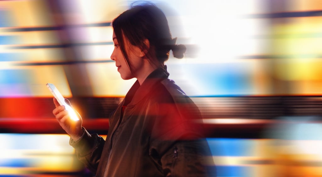 asian woman in black leather jacket, shiny smartphone, colorful low exposure lights