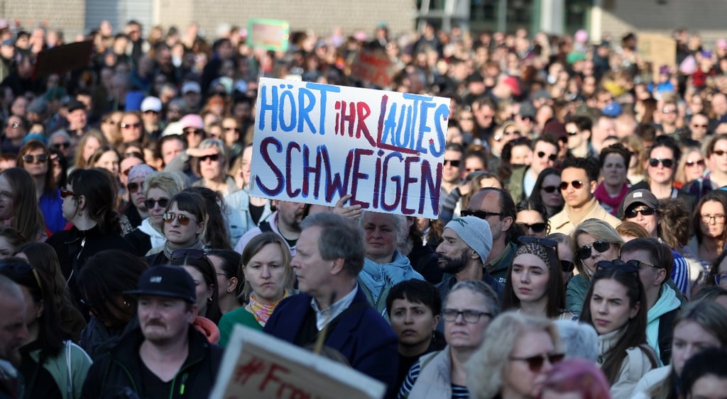 Women hold up placards as they take part in a demonstration in support of Actress Collien Fernandes