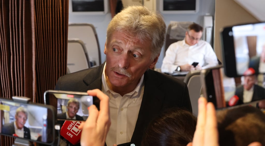 dmitry peskov in plane, three smartphone with his face, grey hair, grey moustache