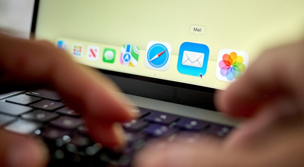 Person using laptop, opening Apple Mail app