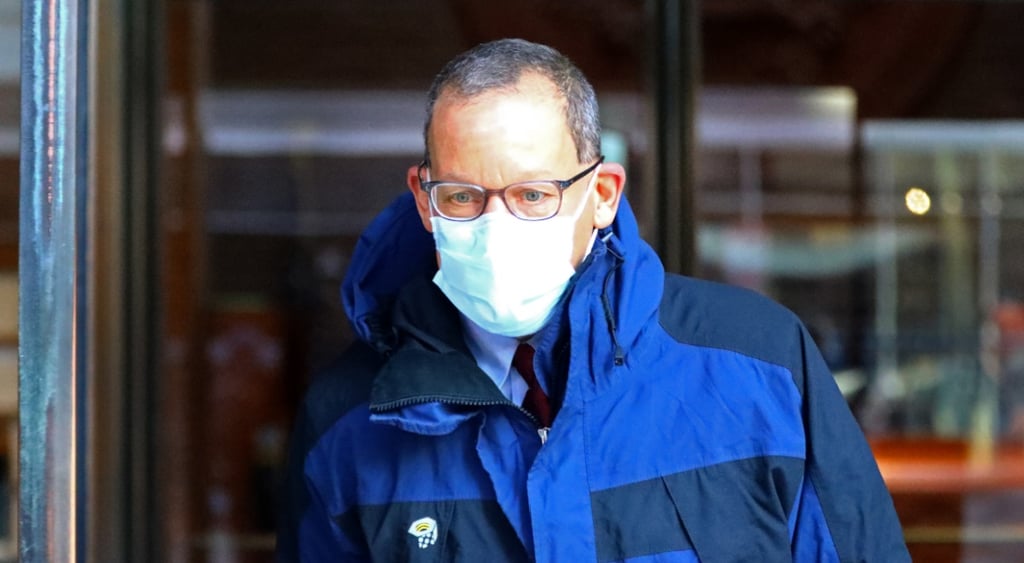 Charles Lieber, blue winter jacket, light blue face mask, glasses, bald forehead,