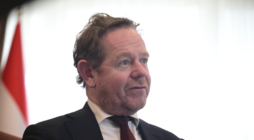 David Van Weel, black suit, bordo tie, white collar shirt, slightly curly light brown hair