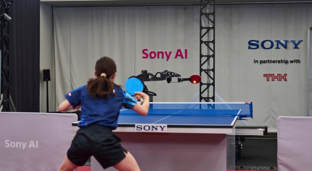 black robot hand, red table tennis racket, woman, black shorts, brown hair, player, SONY