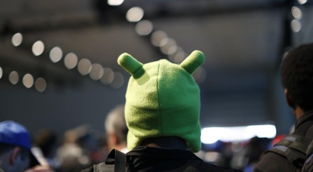 man wearing a sald great hat with two antenas resembling the back of android mascot