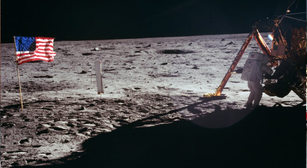 neil armstrong, white space suit, moon surface, grey crator, usa flag