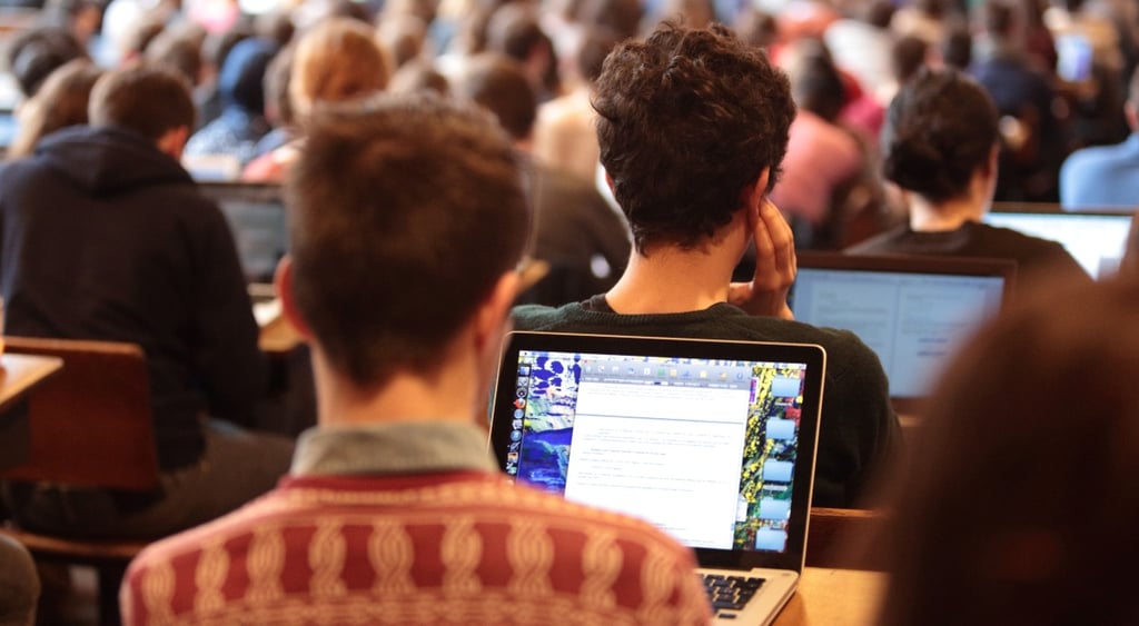 Student with a laptop attending a lecture