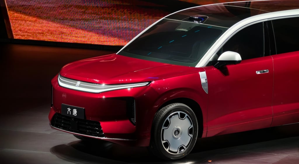 red car on black stage, white frame, white side mirrors, black tires,