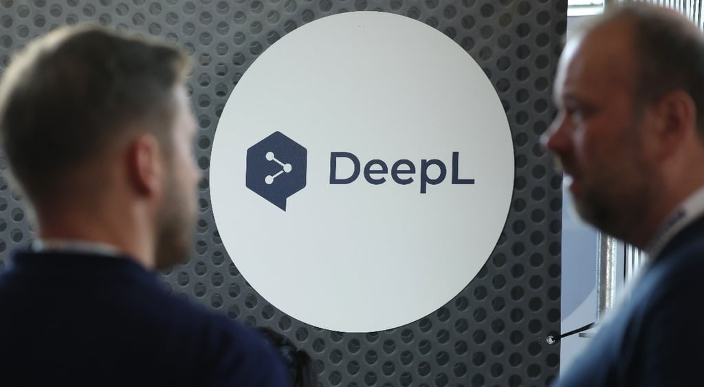 Visitors chat at the DeepL online translation tool stand at the Transform 2026 conference
